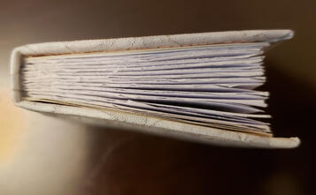 the head of a book with laced on boards