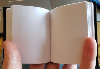 a small casebound book held open